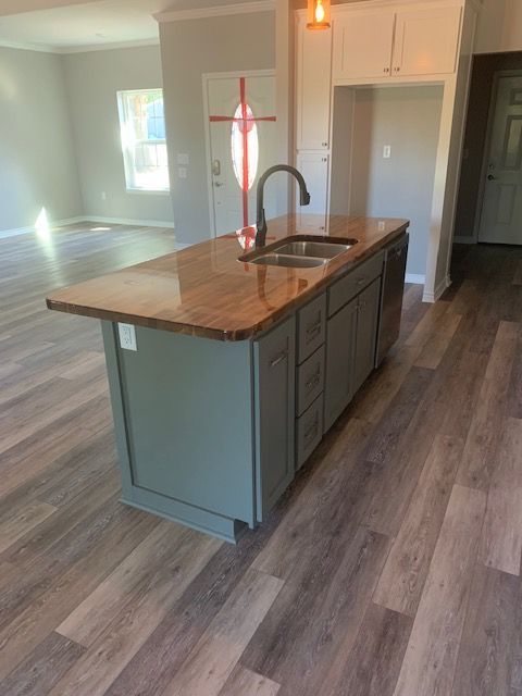 A kitchen with a large island and a sink.