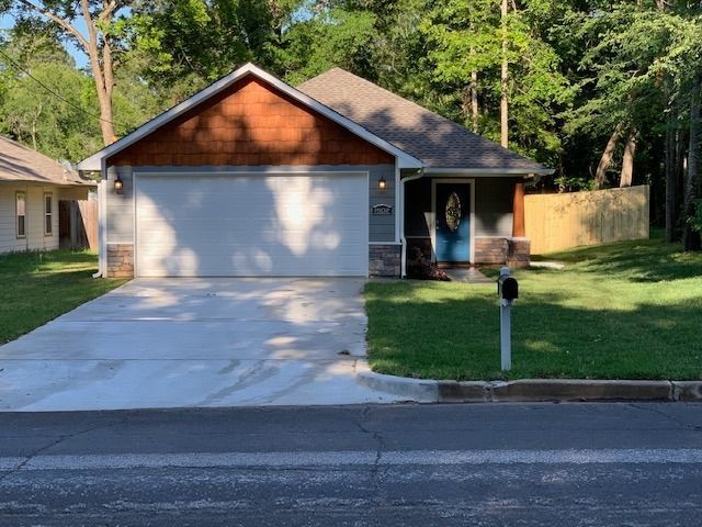 A house with a blue door and a white garage door