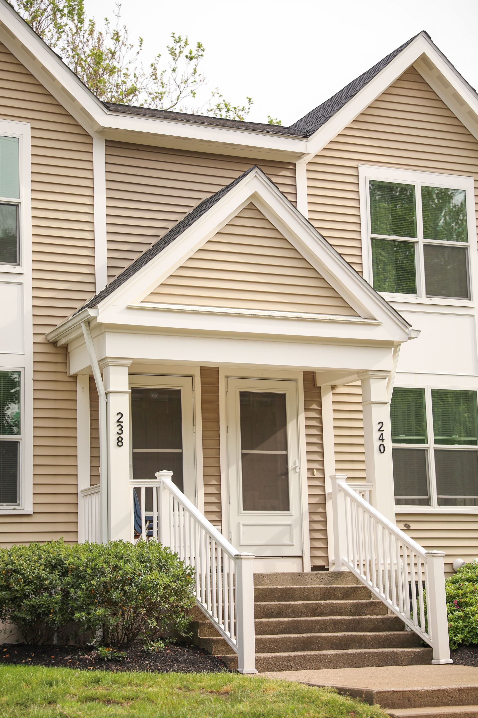 A house with a porch and stairs leading up to it