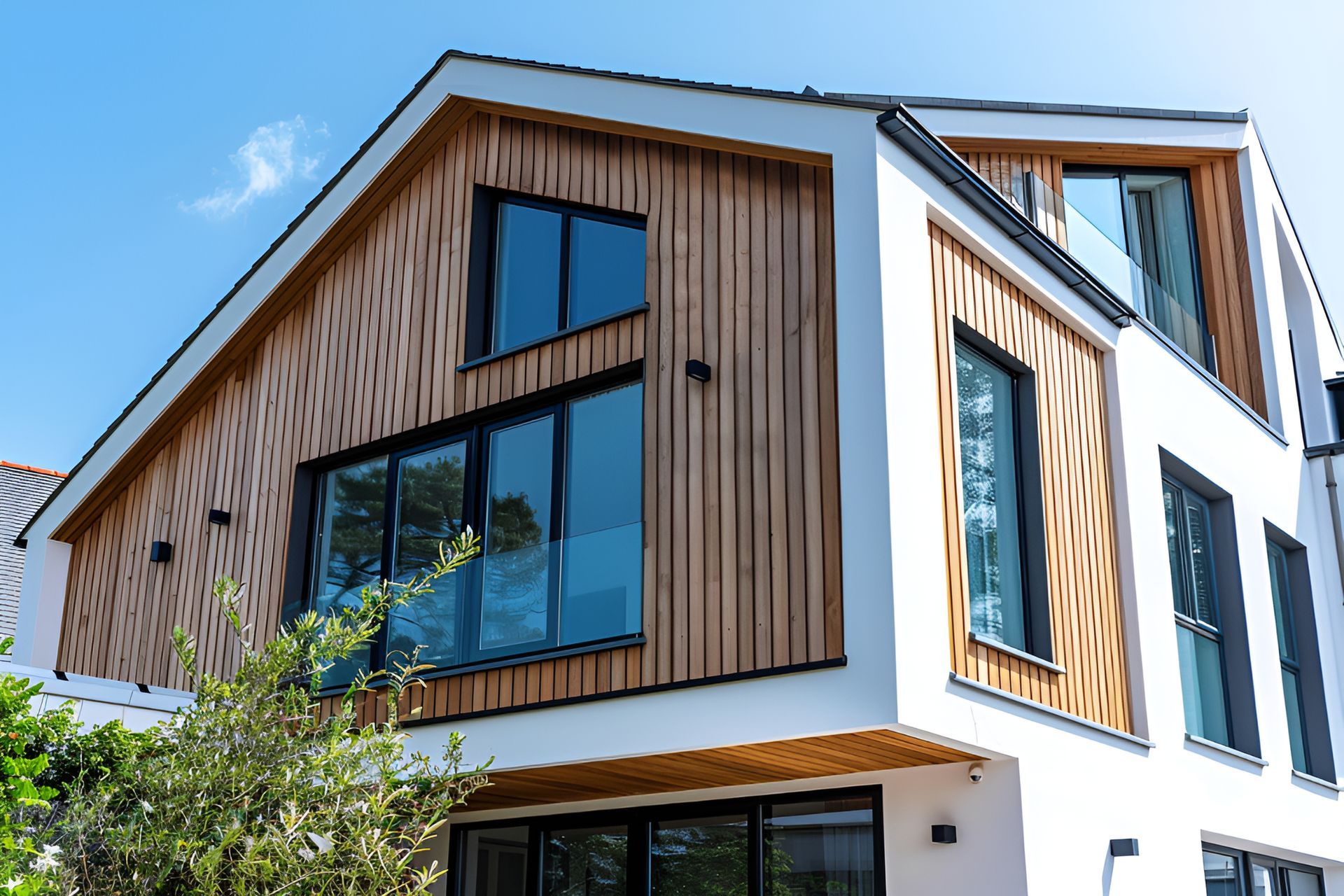 A modern house with a wooden facade and lots of windows.