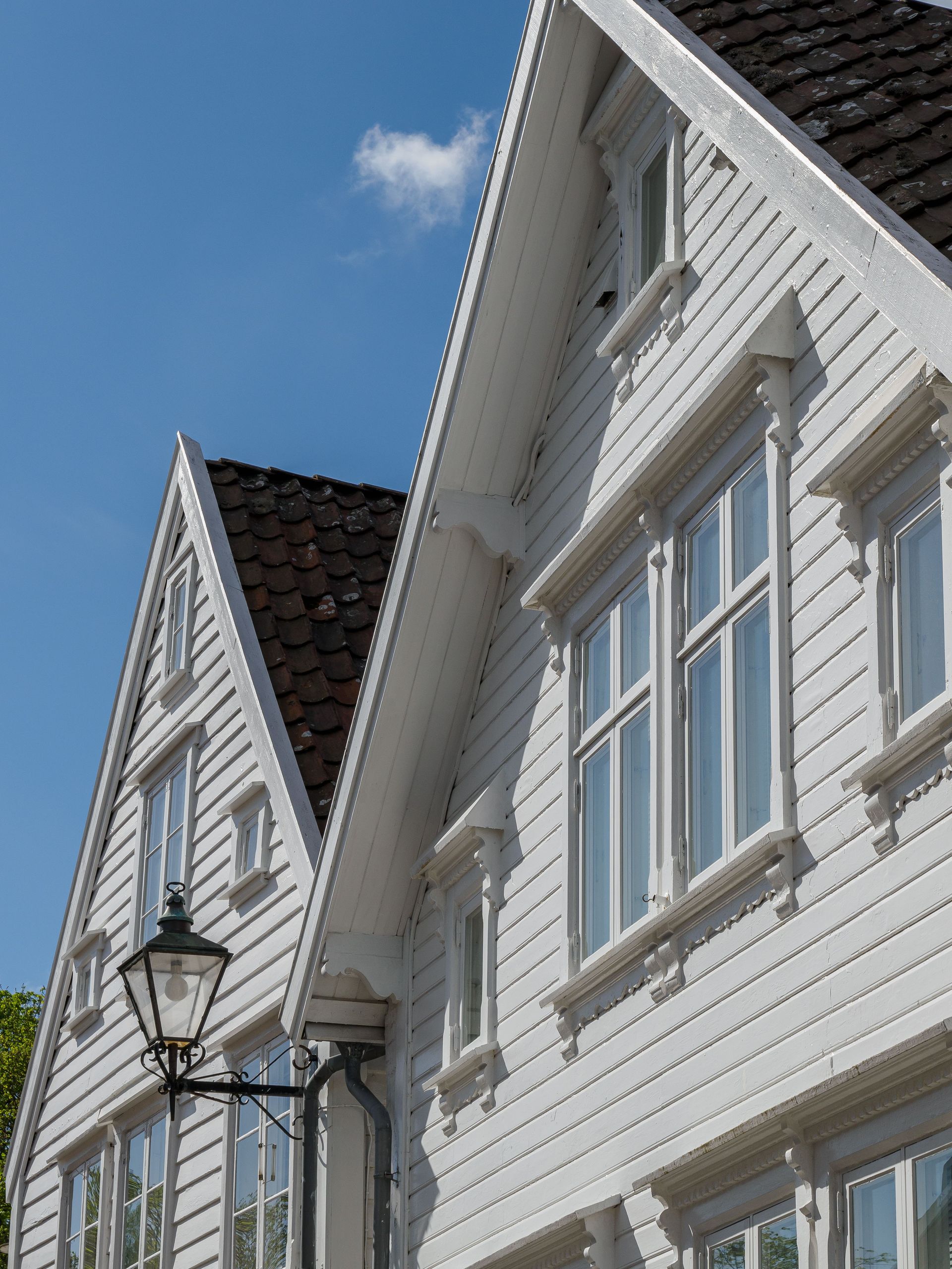 A row of white houses with a brown roof