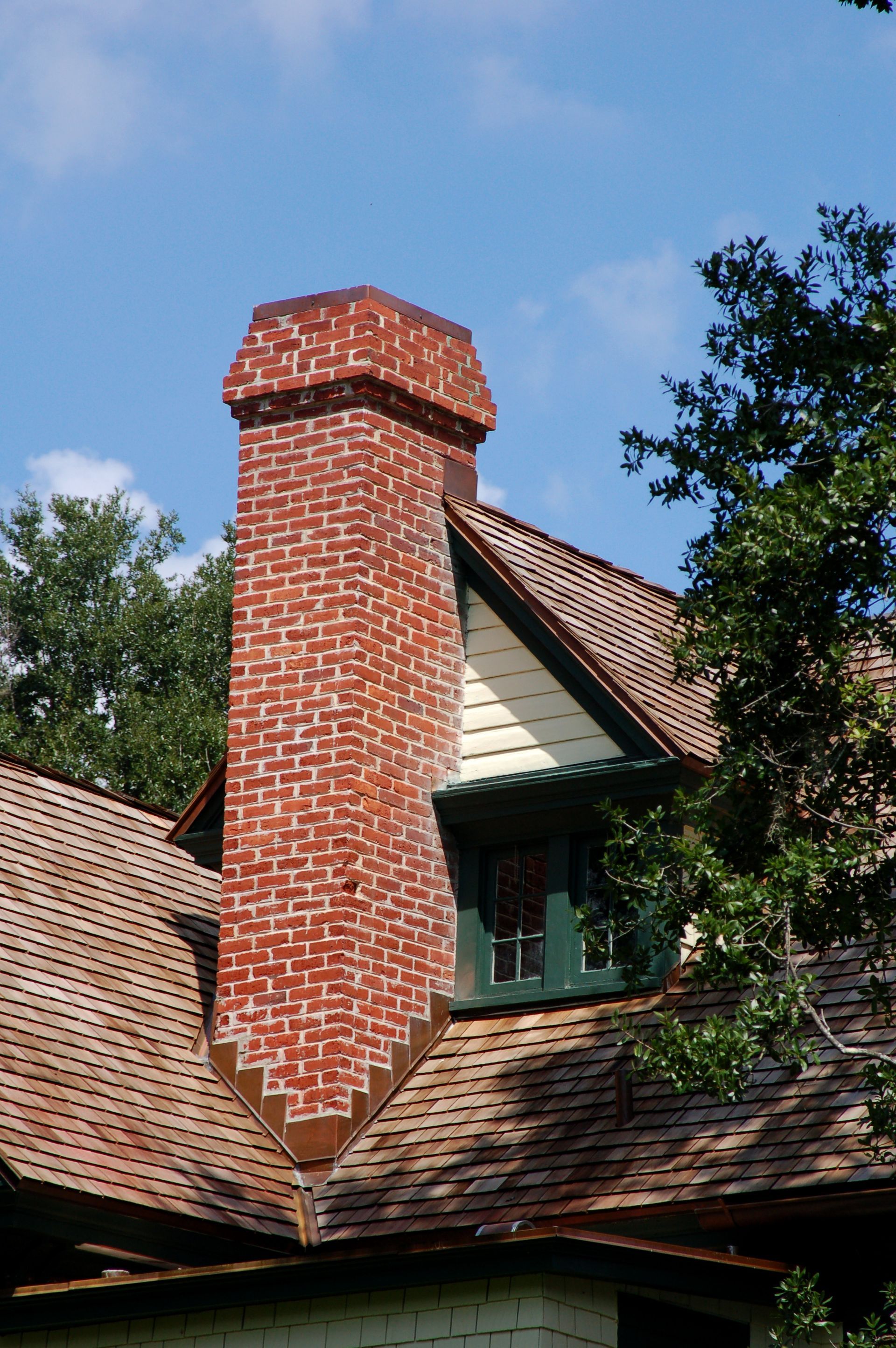 A brick chimney on the roof of a house