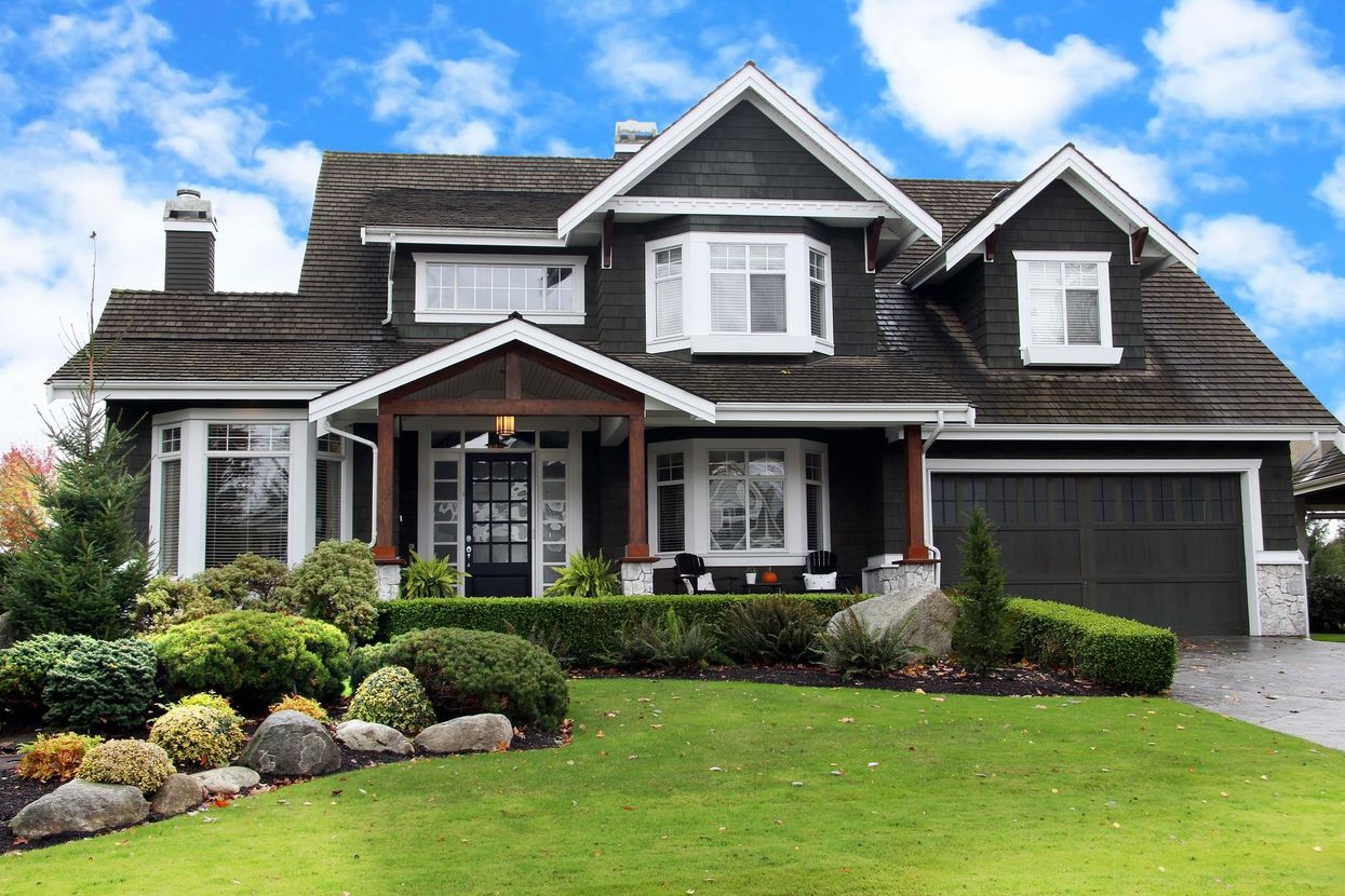 A large house with a large lawn in front of it