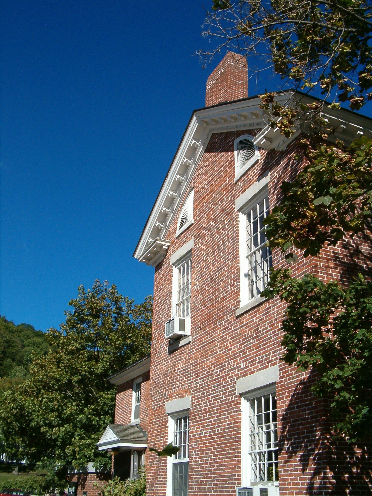 A large brick building with a chimney on top of it