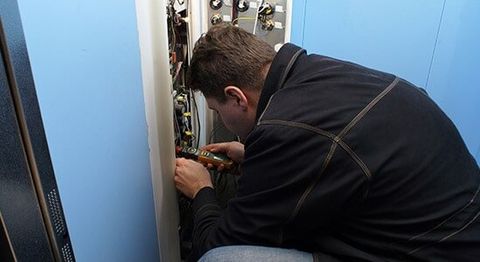 Mechanic Repairing Elevator Button — elevator installation in Bothell, WA
