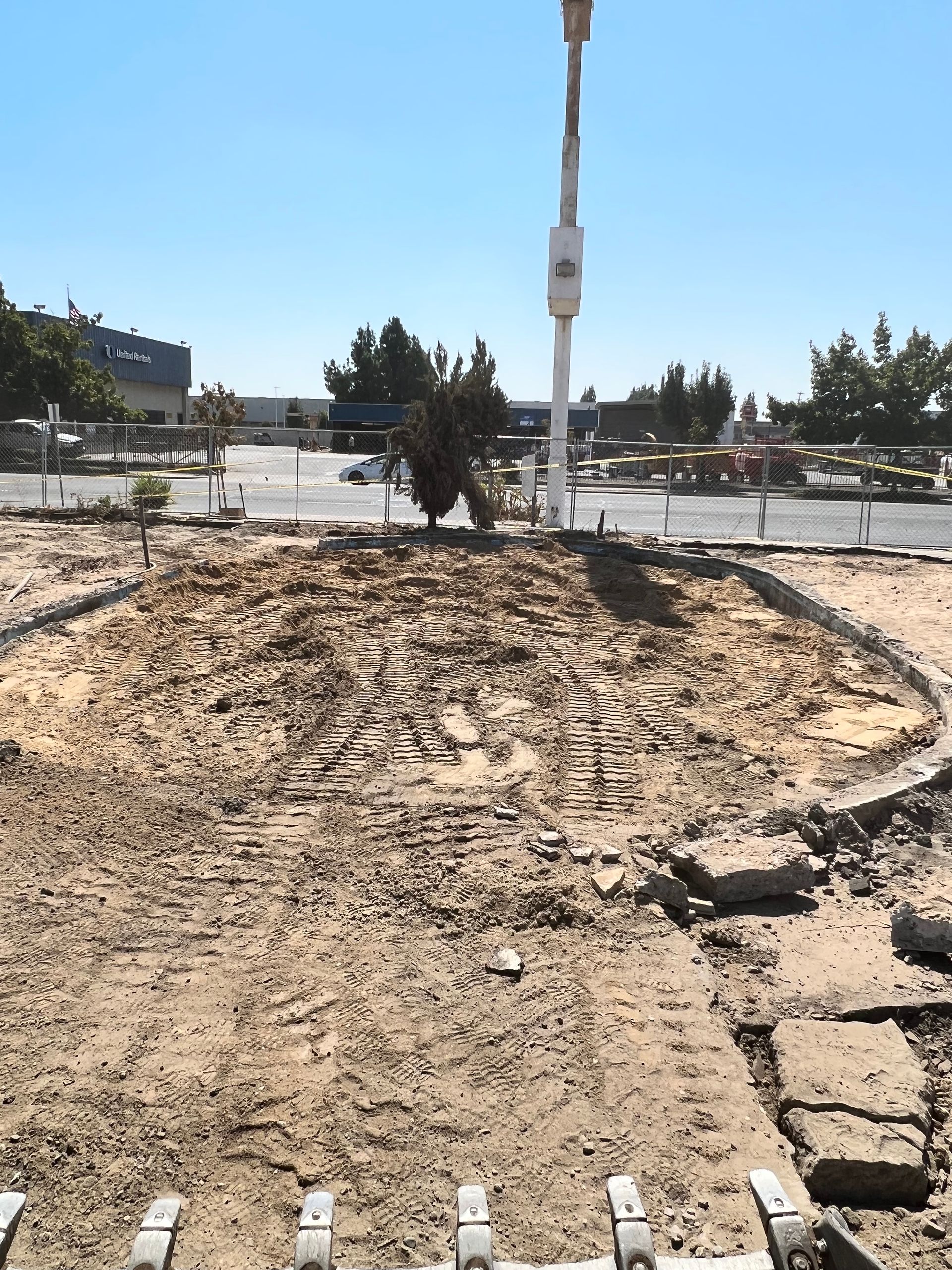 A large pile of dirt with a white pole in the background