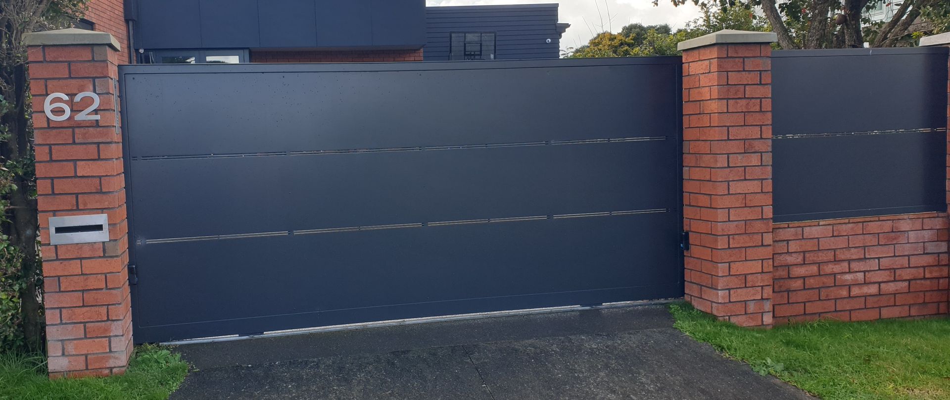 A black gate with the number 62 on it