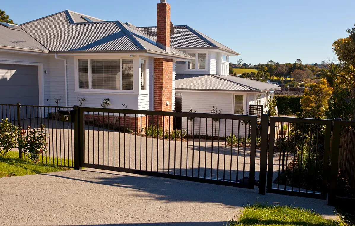 A large white house with a black gate in front of it
