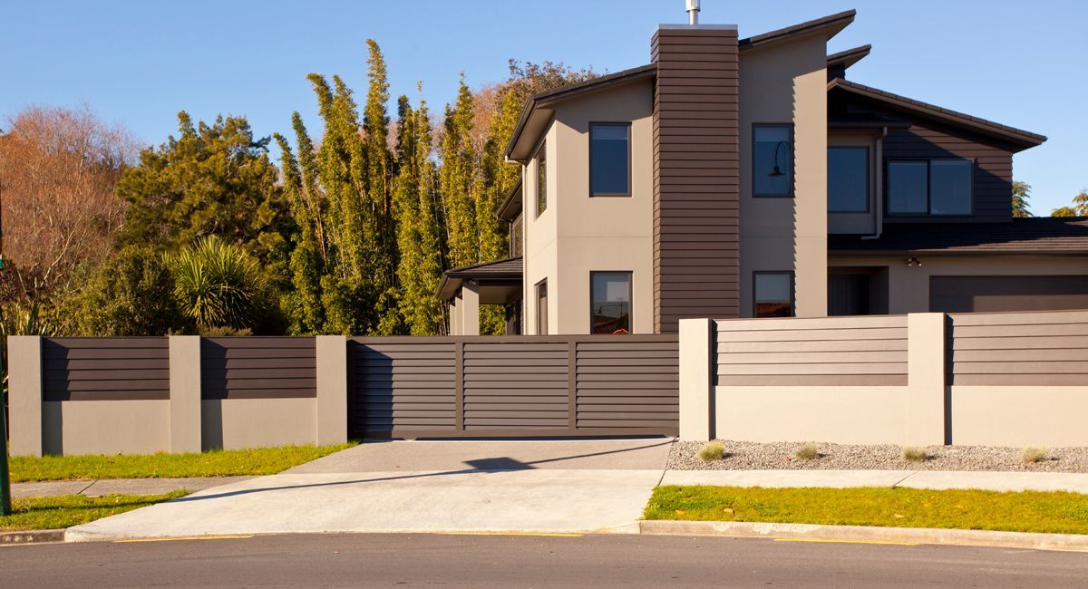 A large house with a fence in front of it