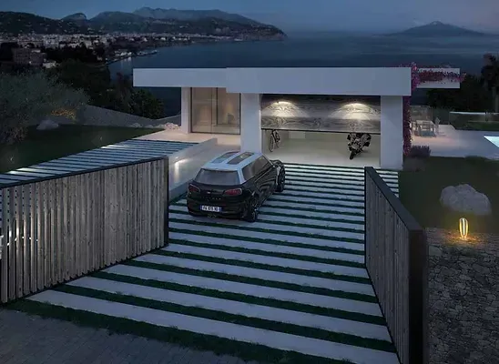 A car is parked in a driveway in front of a house.