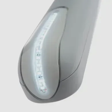 A close up of a gray object with a white light on it.