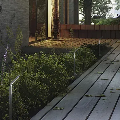 A wooden deck with a bench in the background