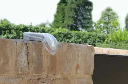 A plastic bag is sitting on top of a brick wall.