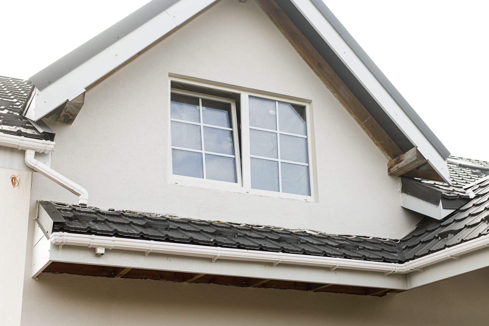 Woman in straw hat smiles, holding wine glass near a lake.