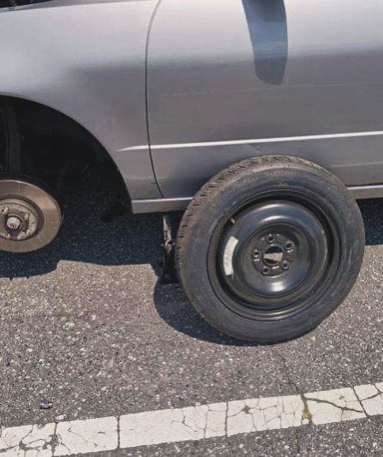 A car with a spare tire on the side of it