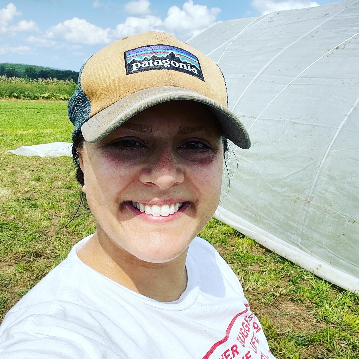 smiling near high tunnel