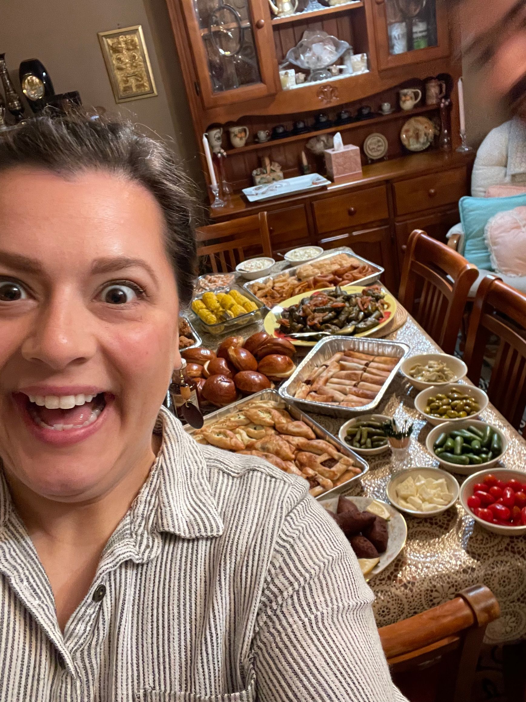 silly face with a large table full of food in the background