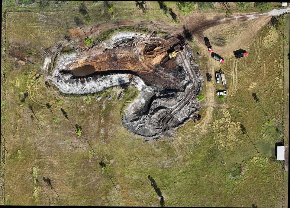Family gathered at a dining table in a kitchen. They are eating and talking together.
