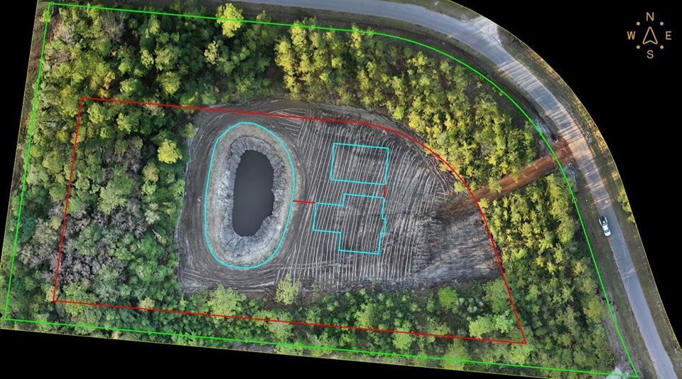 A person holding a baby up in the air indoors near a window, baby smiling.