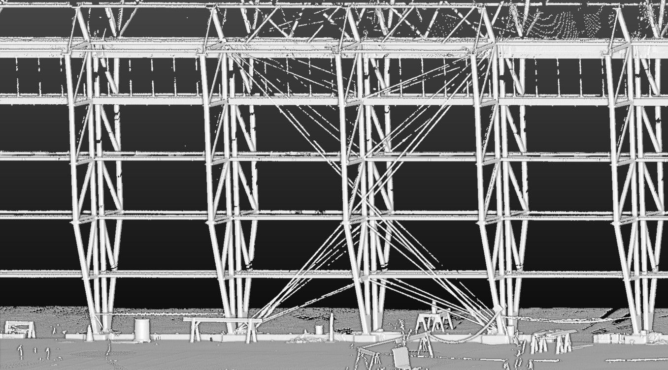 A technical scan showing the repetitive steel framework and structural beams of a building’s exterior.