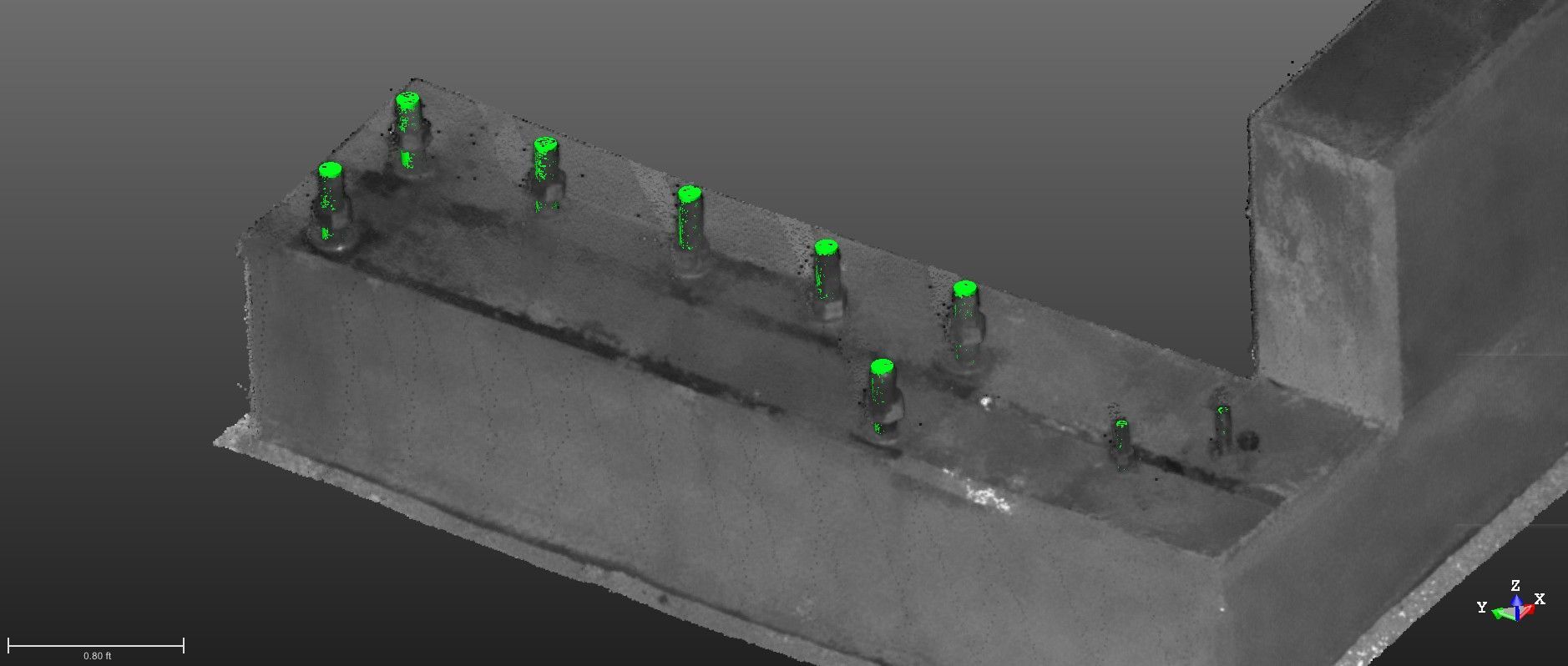 A 3D point cloud model of an aircraft hangar interior, with the massive door frame as the focal point. The scan data appears as a dense collection of gray and white dots outlining the structure. Superimposed on this point cloud are several bright green, digitally modeled anchor bolts, showing their precise planned locations for securing the large door.