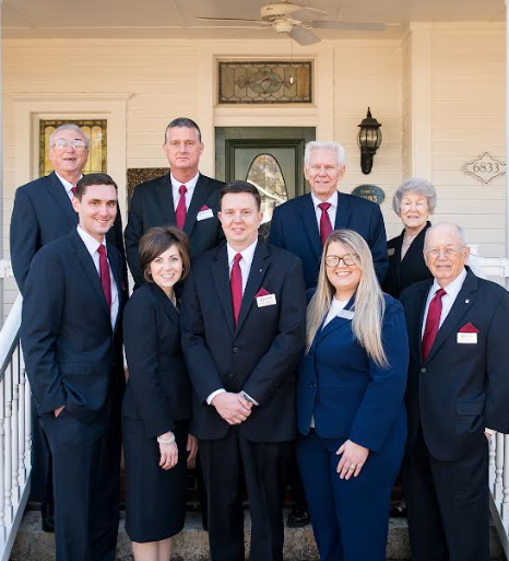 A fountain in a park with palm trees in the background