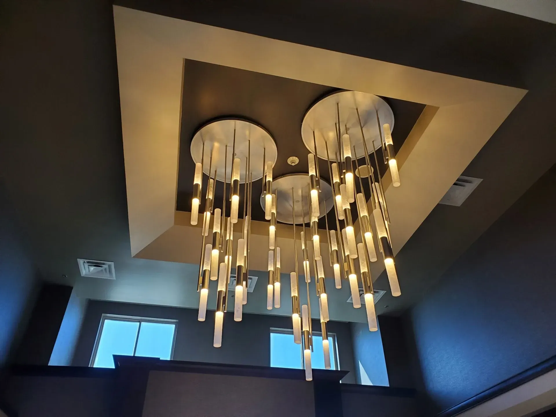 A large chandelier is hanging from the ceiling of a room