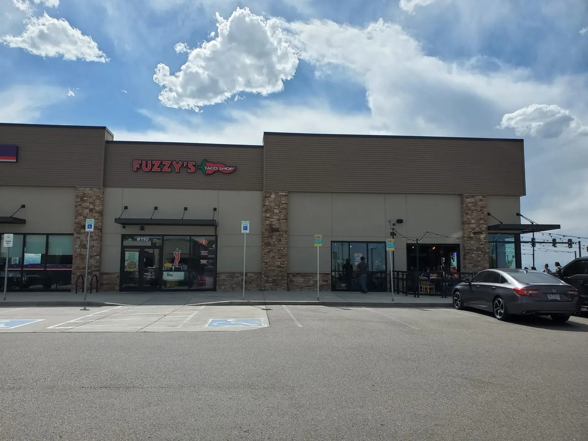 A large building with a car parked in front of it.
