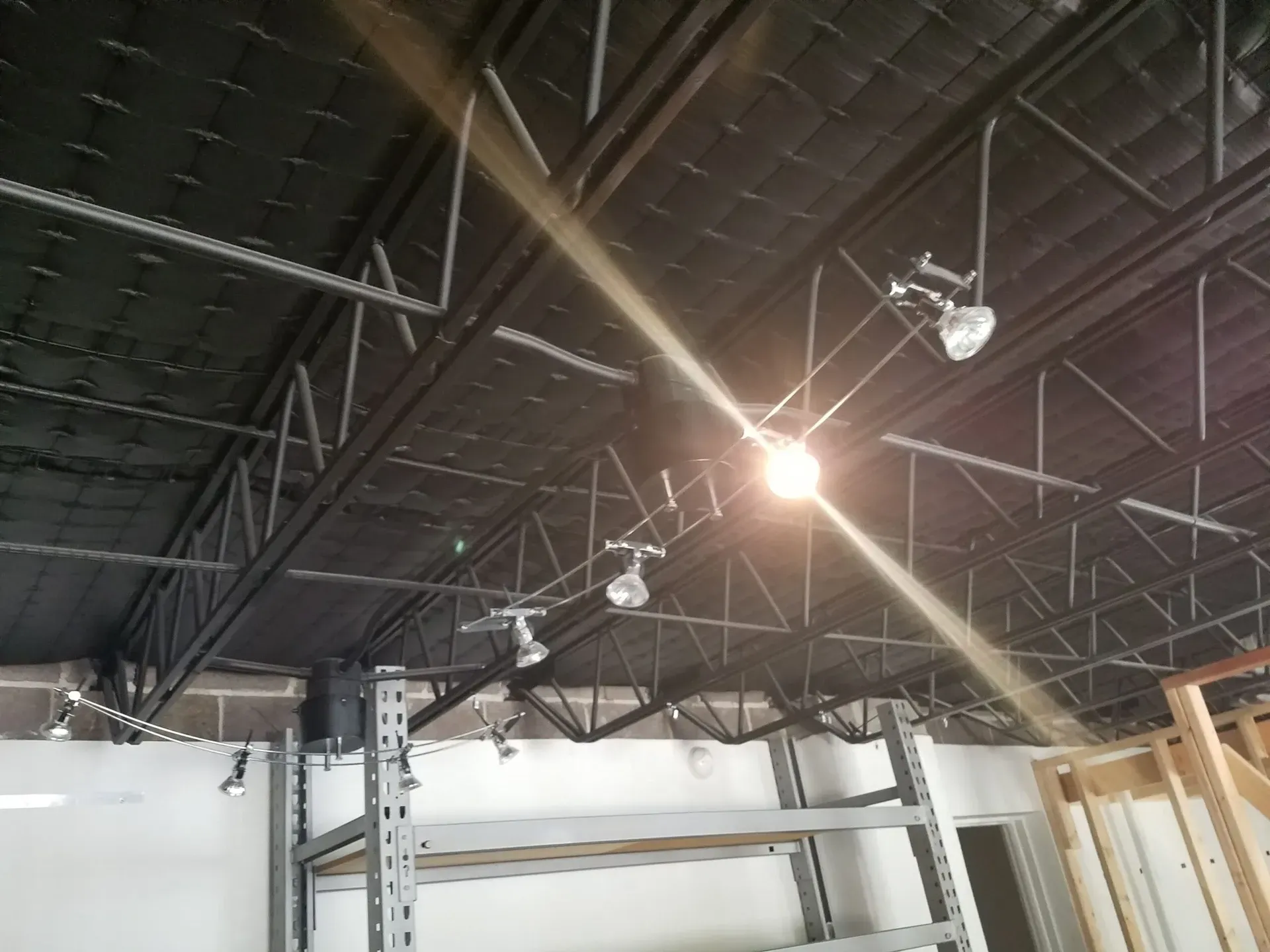 A light is shining through the ceiling of a building