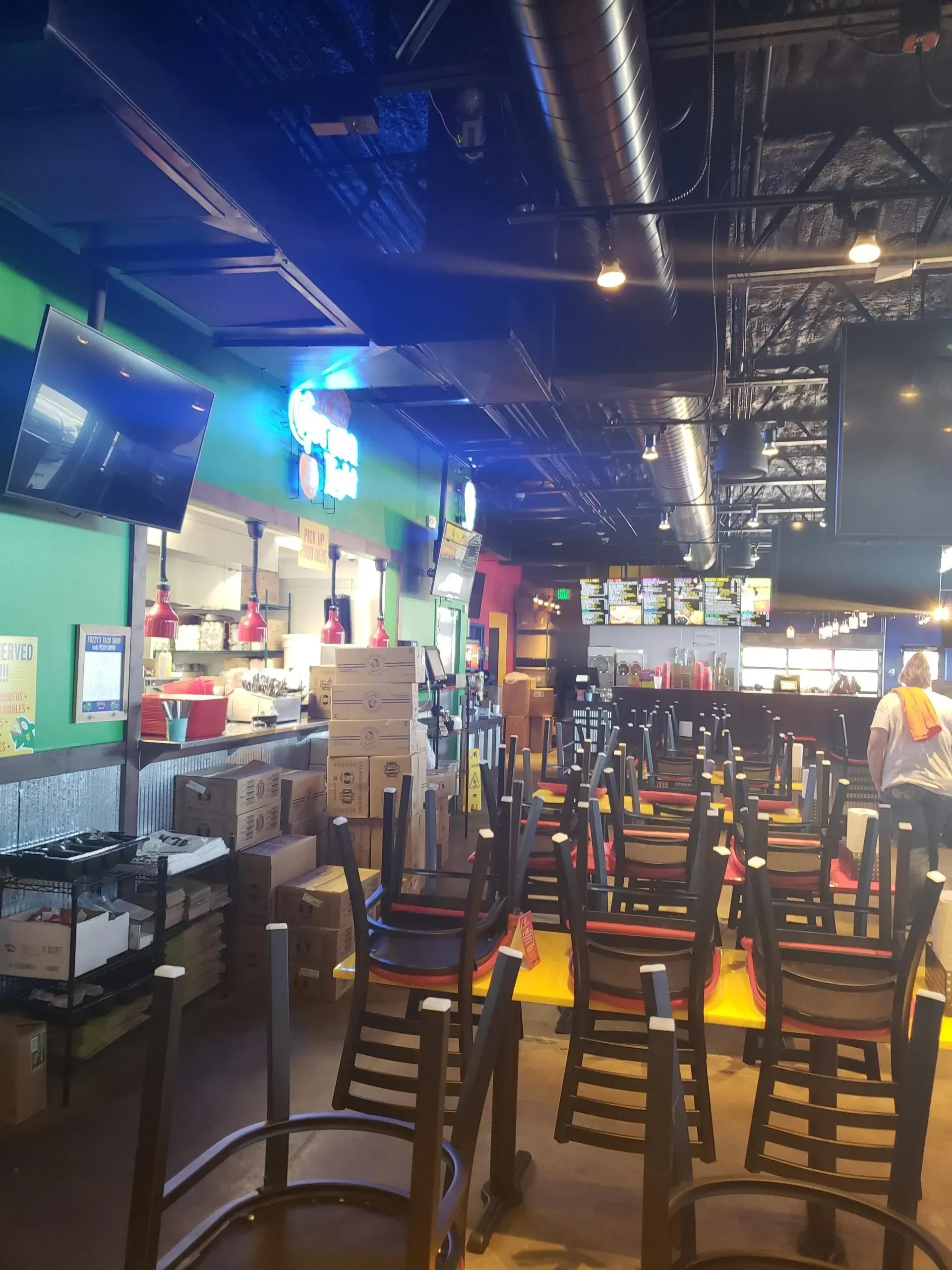 A restaurant with tables and chairs that are empty