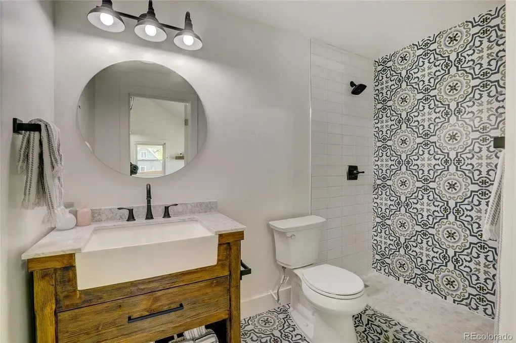 A bathroom with a sink , toilet , and mirror.