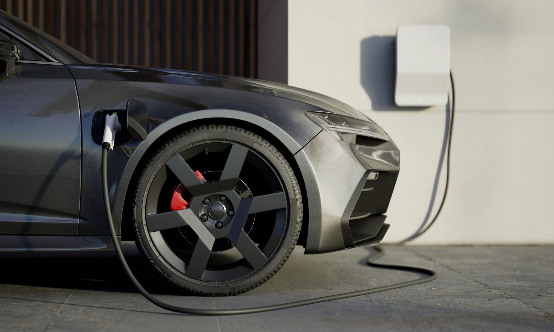 A black electric car is being charged at a charging station.