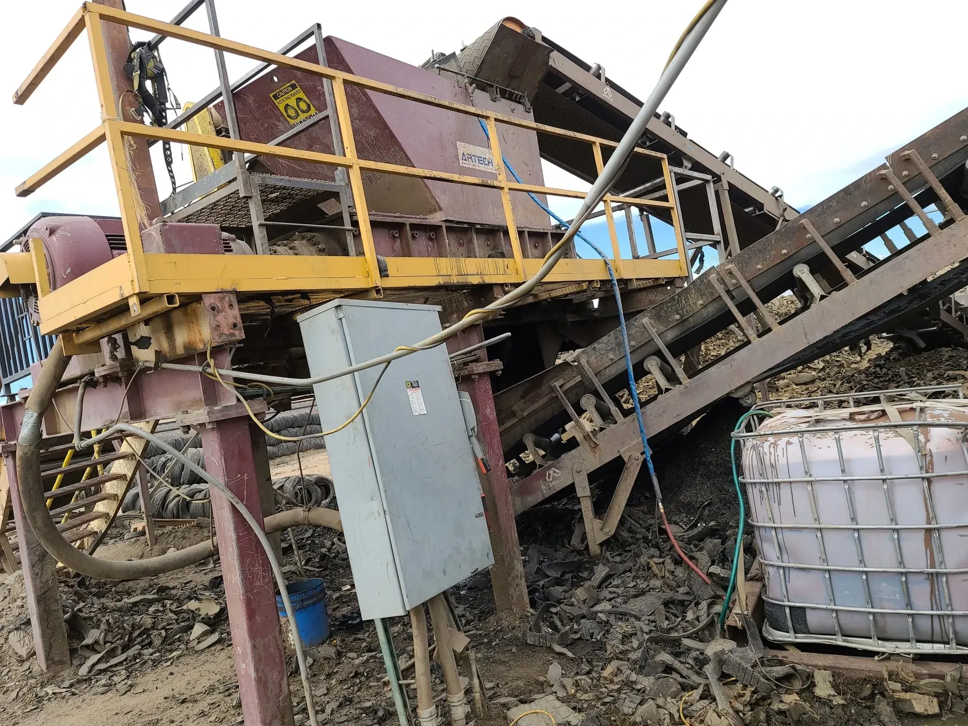 A large machine is sitting on top of a pile of dirt.