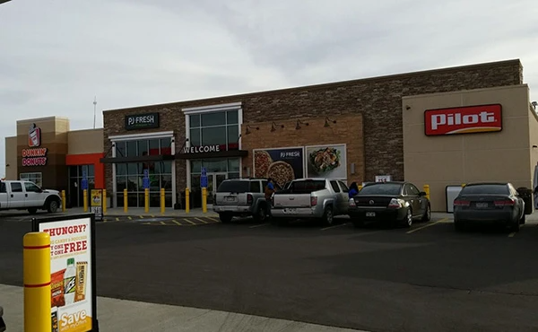 A pilot gas station with cars parked in front of it