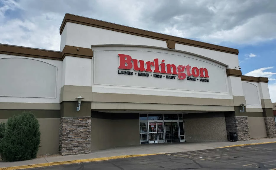 The front of a burlington store with a cloudy sky in the background