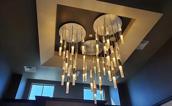 A large chandelier is hanging from the ceiling in a room