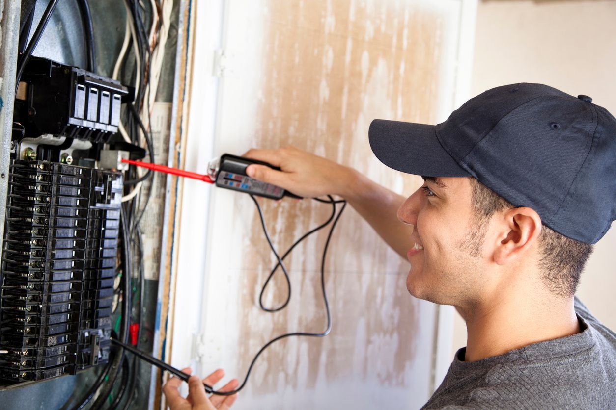 Electrician installing a new electrical panel in a Denver, Colorado home.