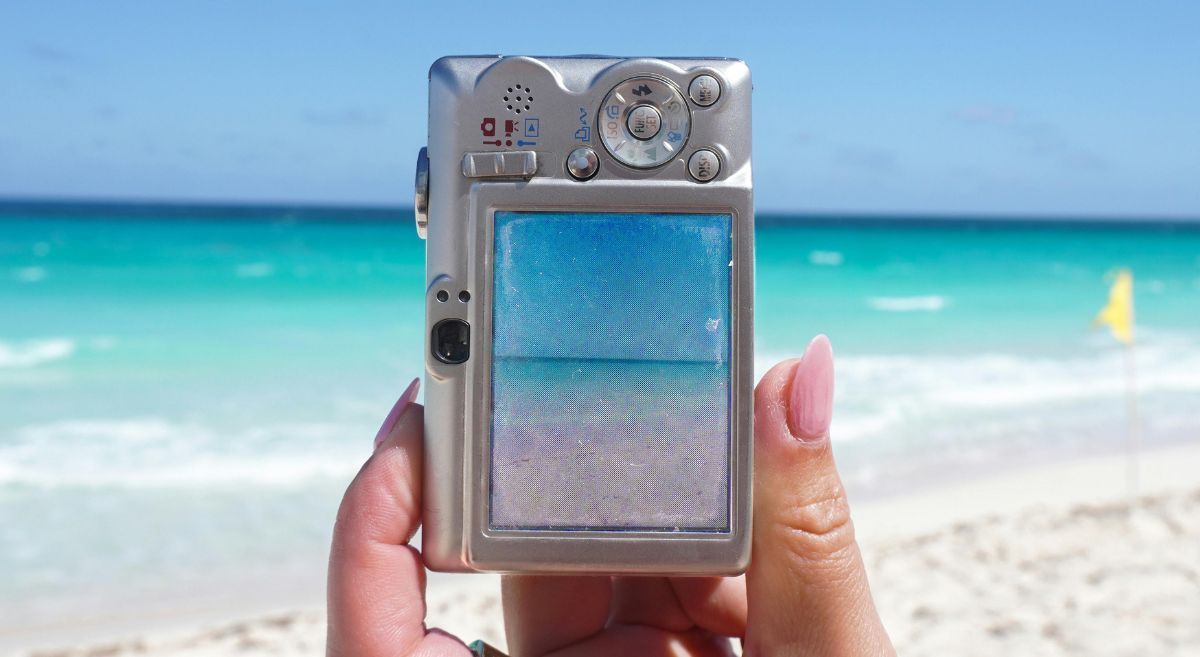 A person capturing meaningful vacation memories on the beach