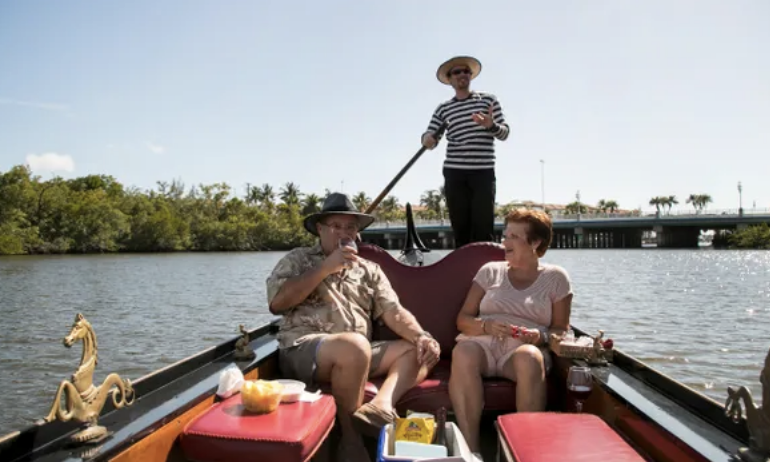 A man and a woman are sitting in a boat on a river.