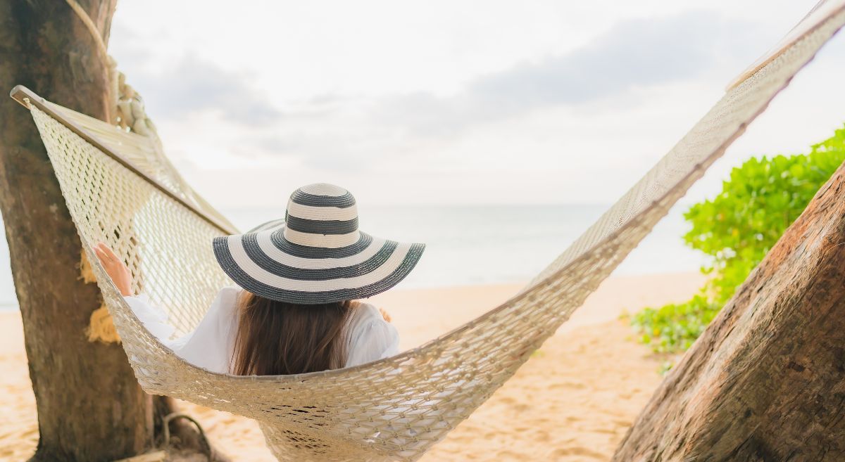 A woman in a hammock enjoying a boutique vacation in Naples.