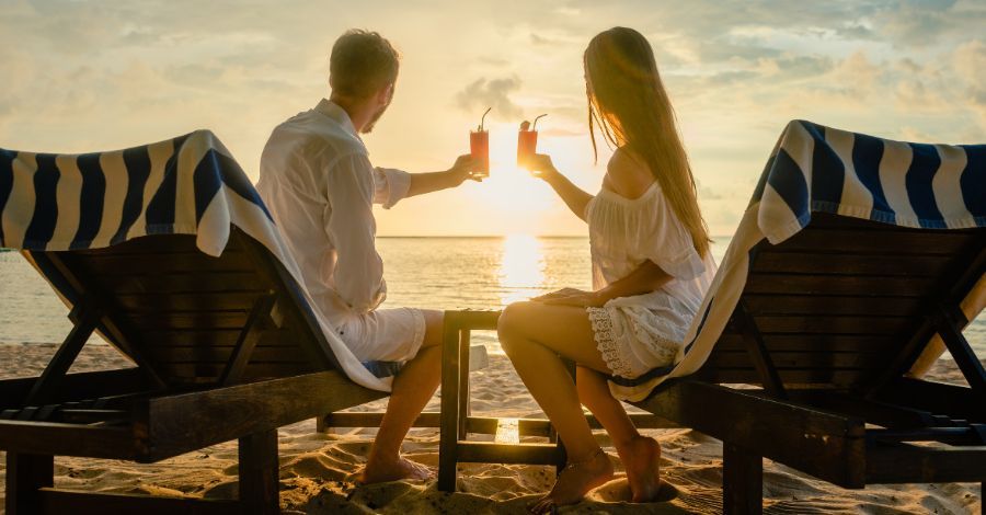 A couple celebrating a honeymoon on the beach.