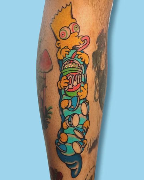 A person has a tattoo of bart simpson drinking a soda