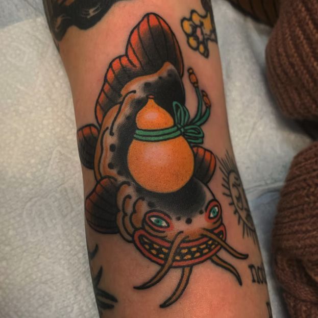 A tattoo of a fish with a gourd on its head