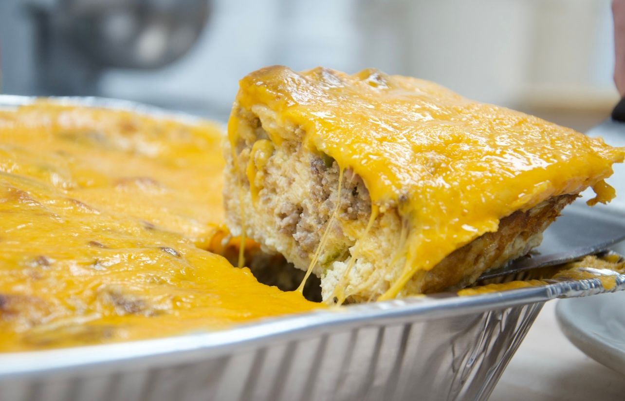 A close up of a casserole dish with a slice taken out of it.