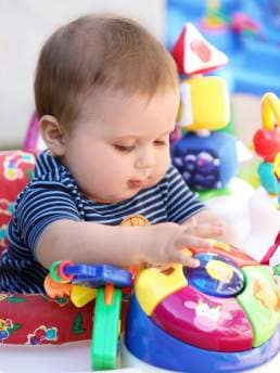 Infant child playing with toys - Cottage School , Boulder, Colorado