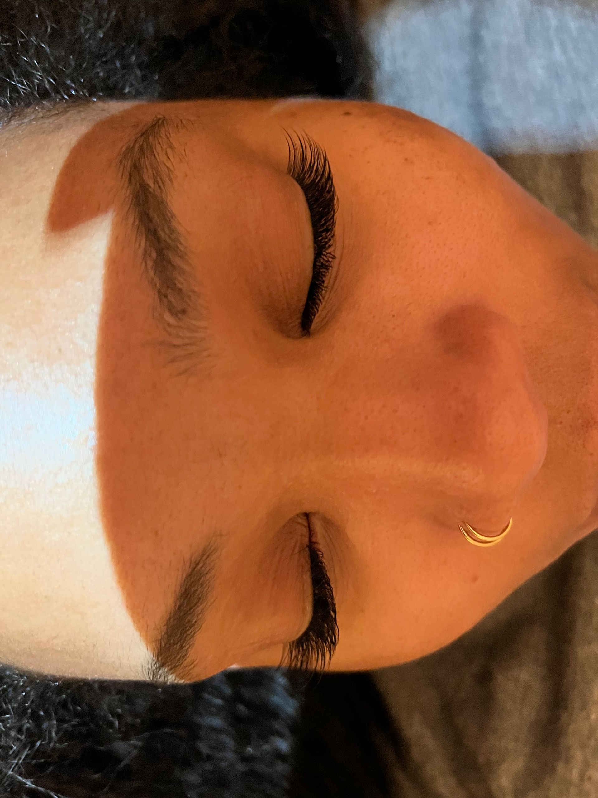 A close-up of a person's face with eyes closed.