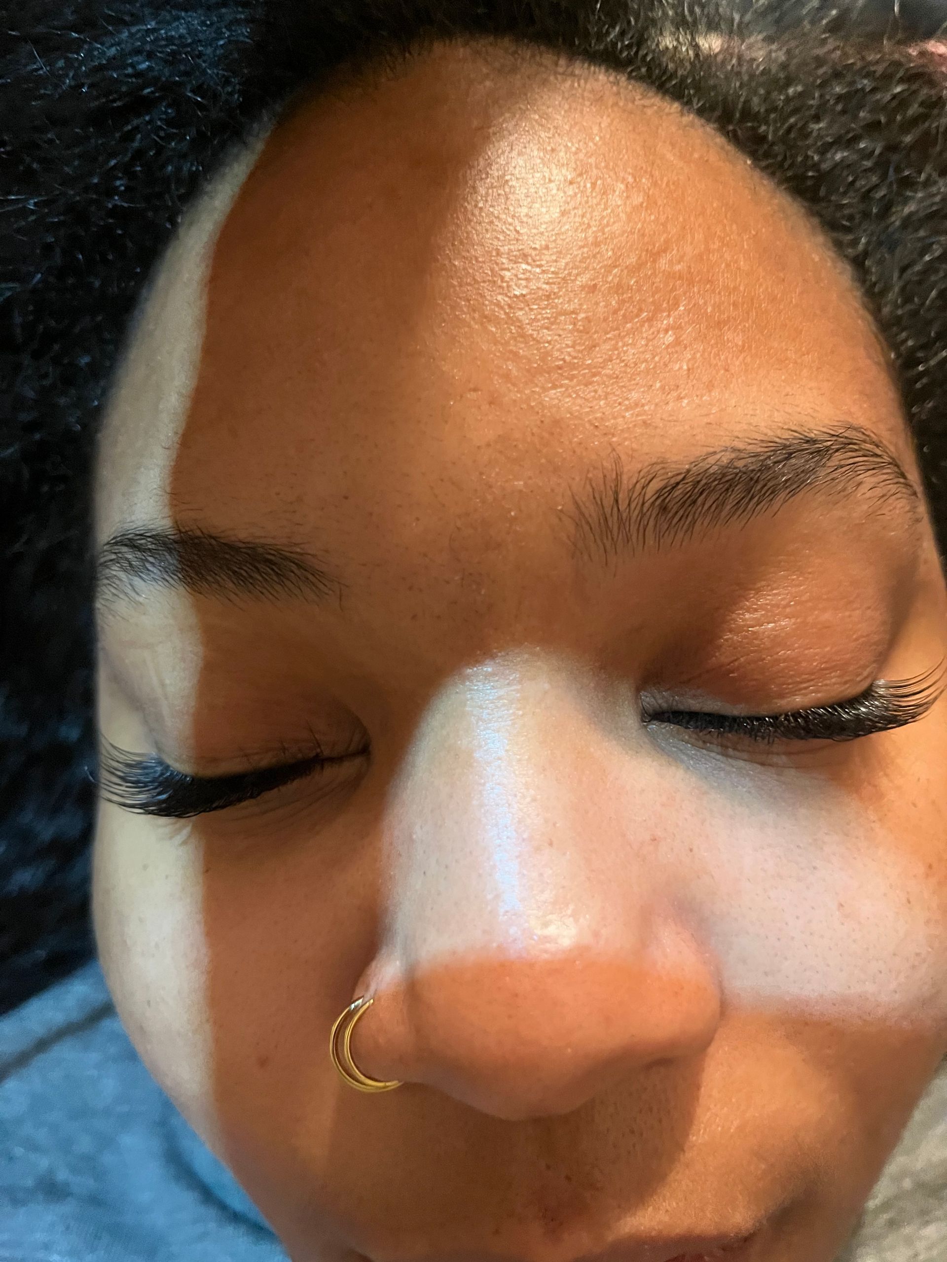 A close-up of a person's face with eyes closed.