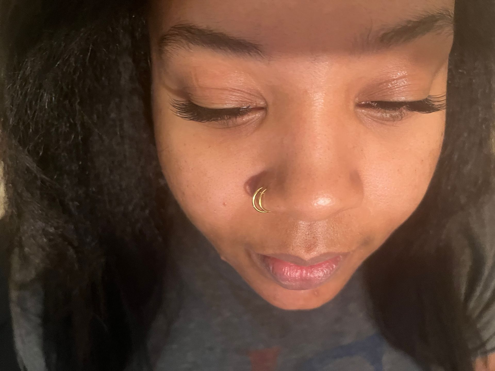 A close-up of a person's face with eyes closed.