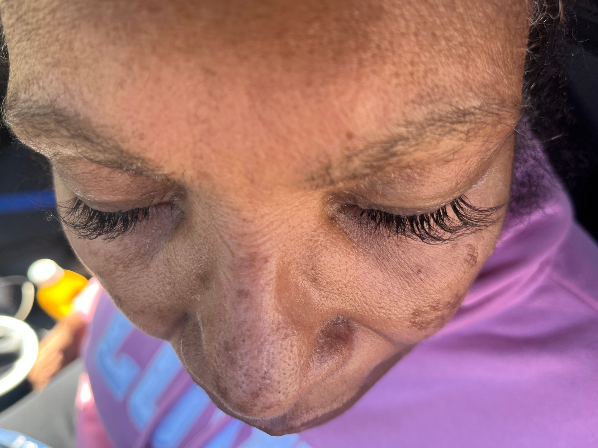 A close-up of a person's face with eyes closed.