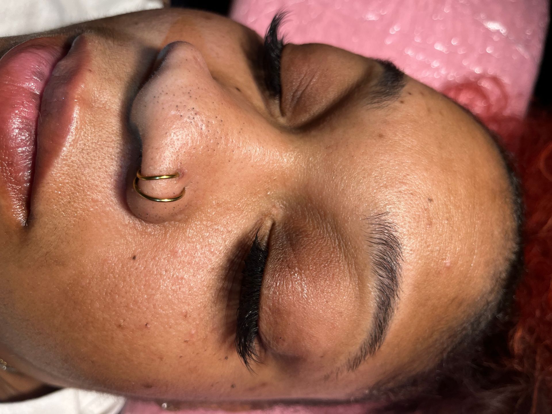 A close-up of a person's face with eyes closed.